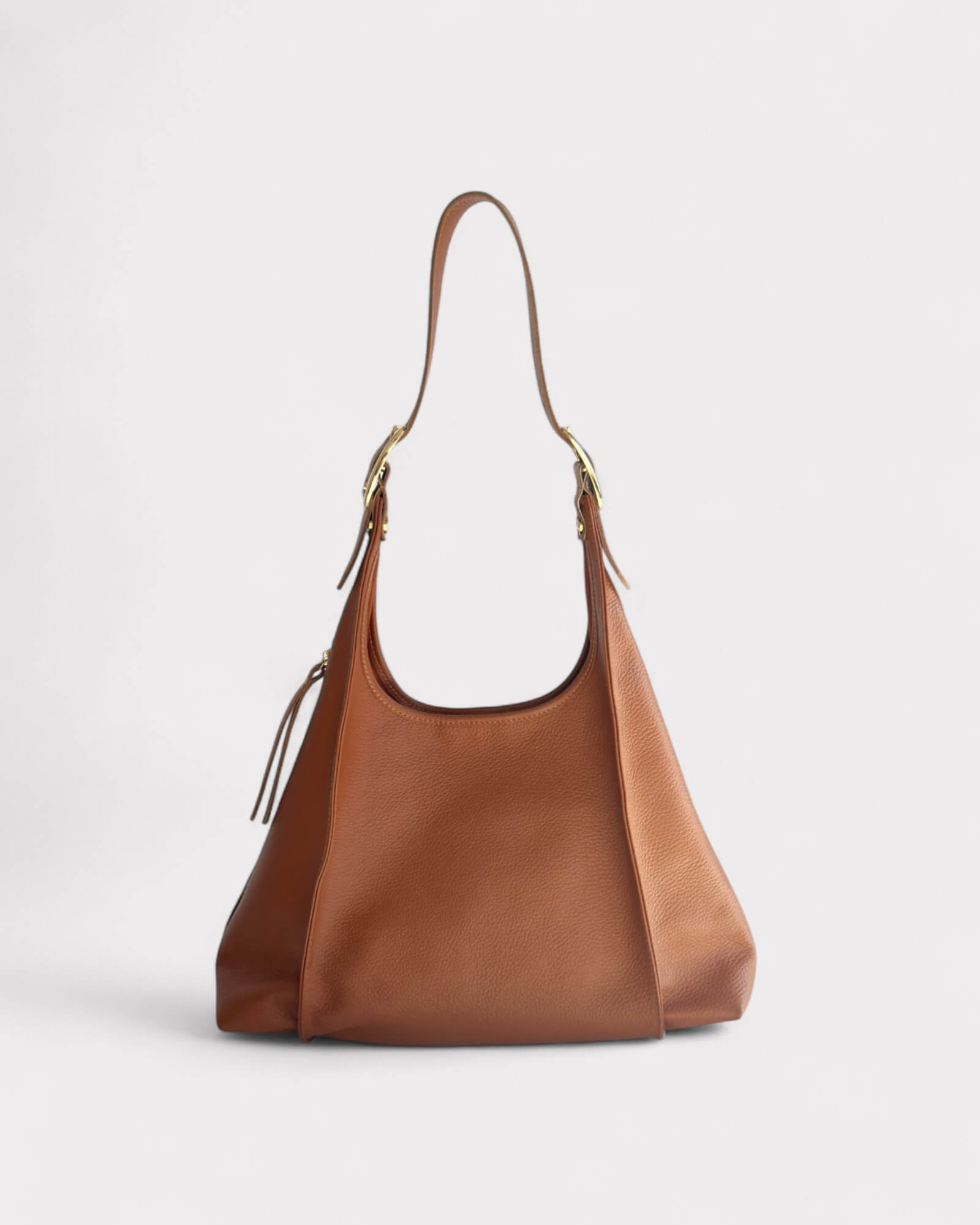 Tan leather handbag on a light gray background