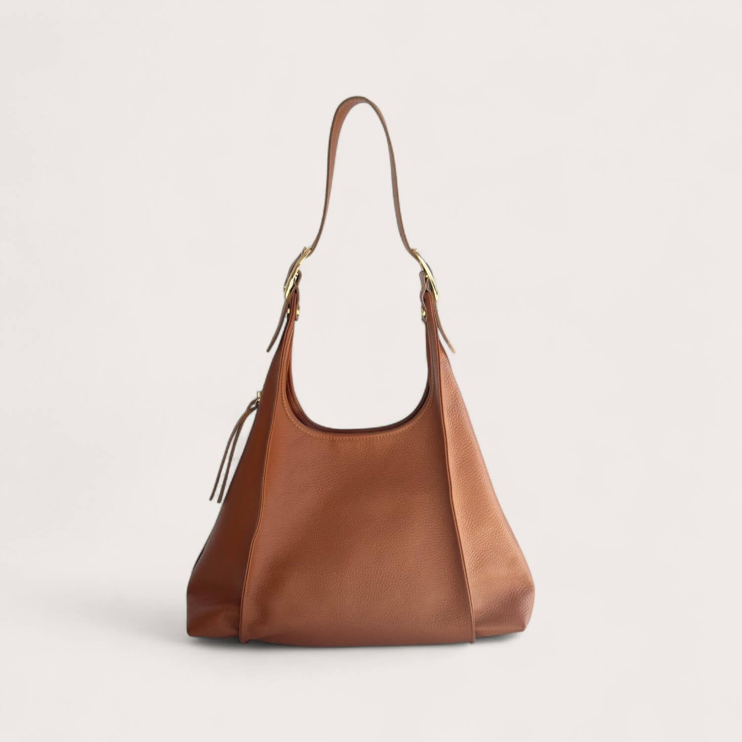 Tan leather handbag on a light beige background