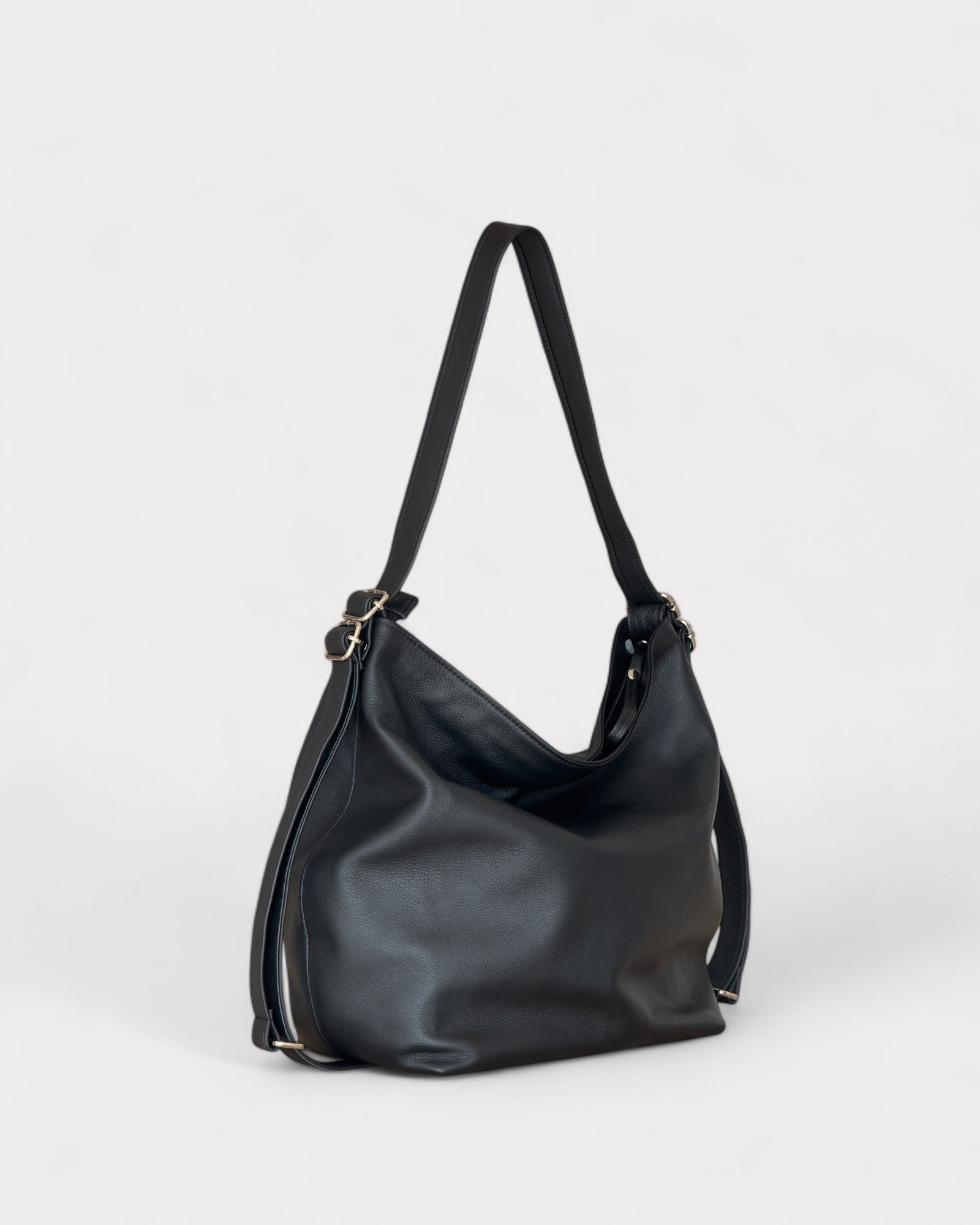 Black leather handbag on a light gray background