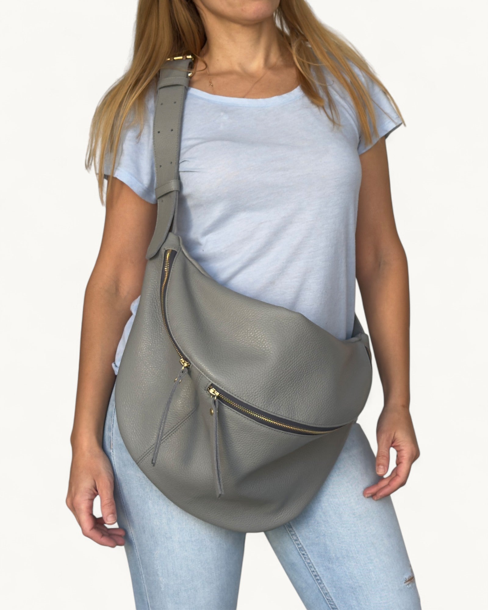 Person wearing a gray shoulder bag on a white background