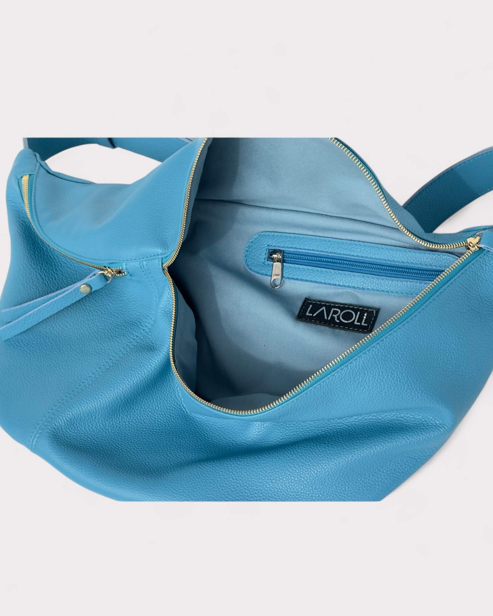 Blue handbag with gold zippers on a white background