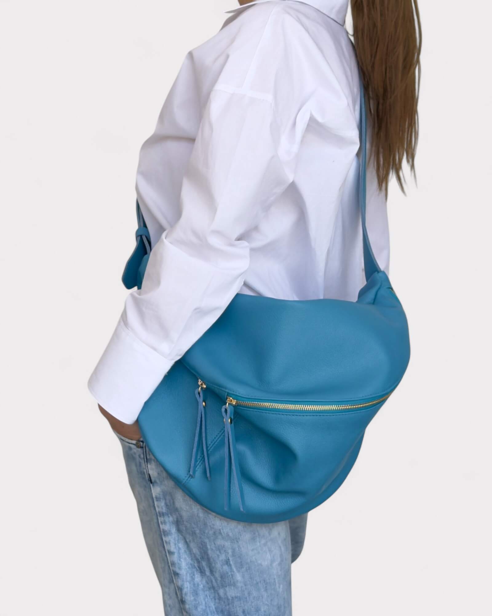 Person wearing a blue bag on a plain background