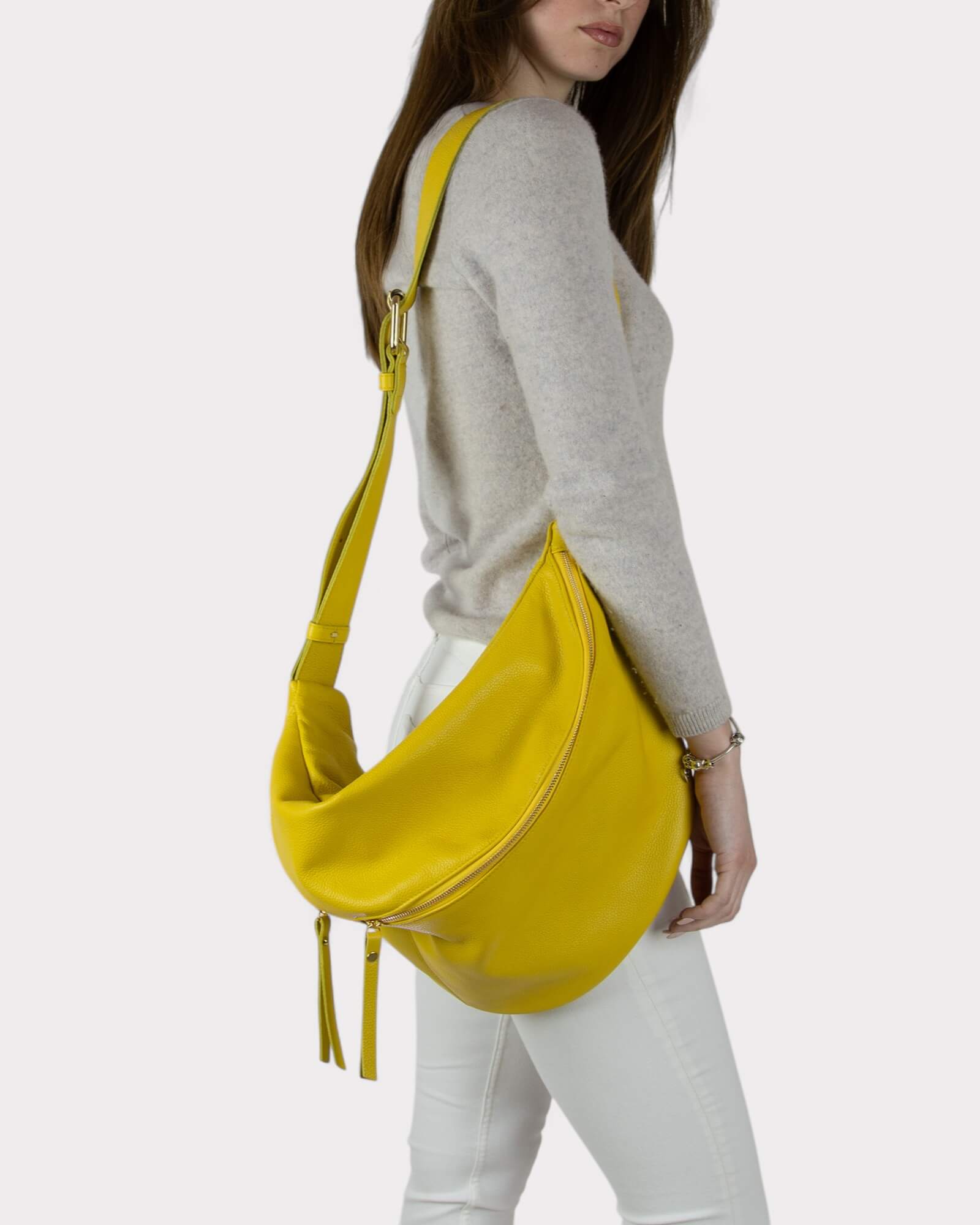 Woman carrying a yellow bag on a white background