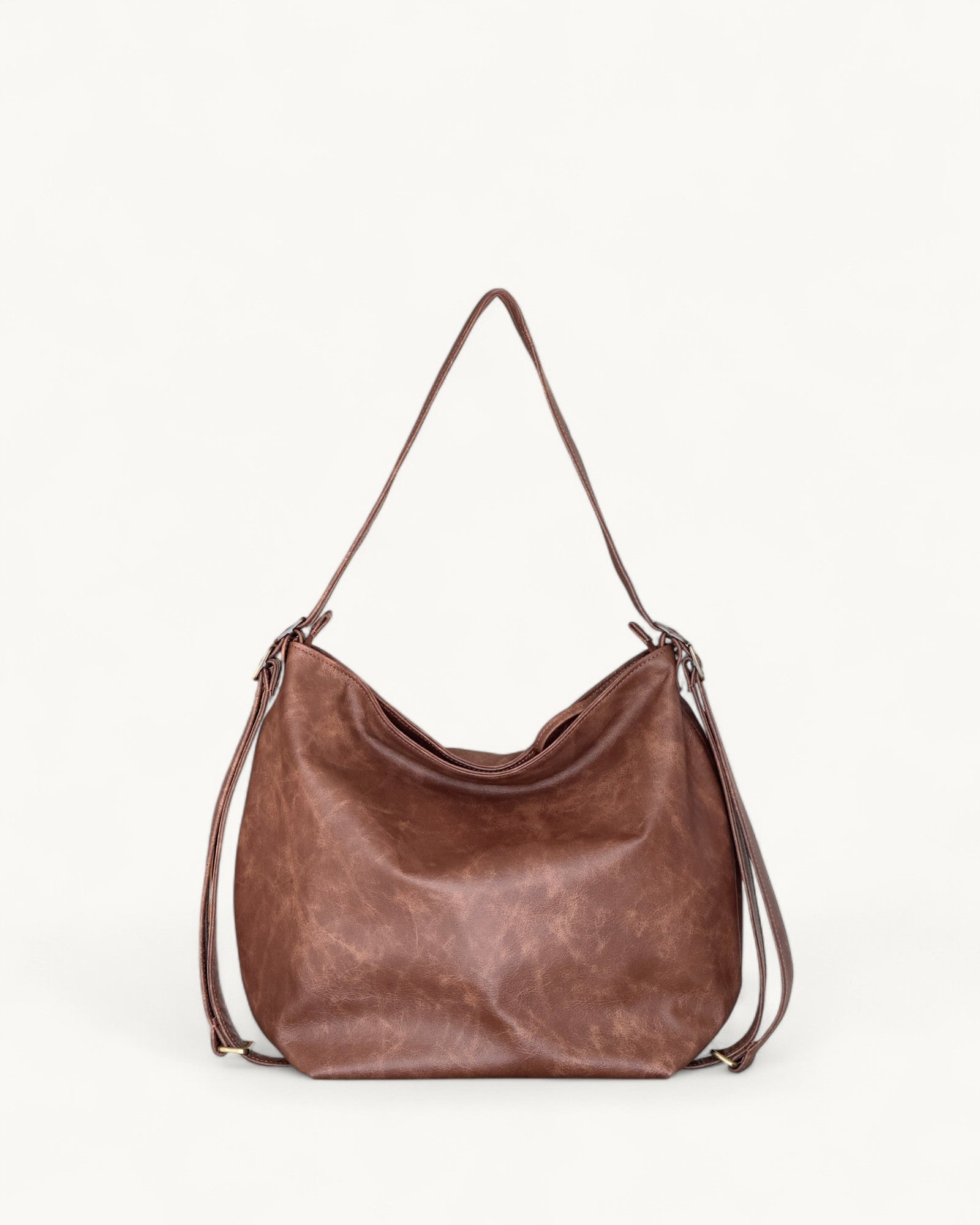 Brown leather handbag on a light gray background