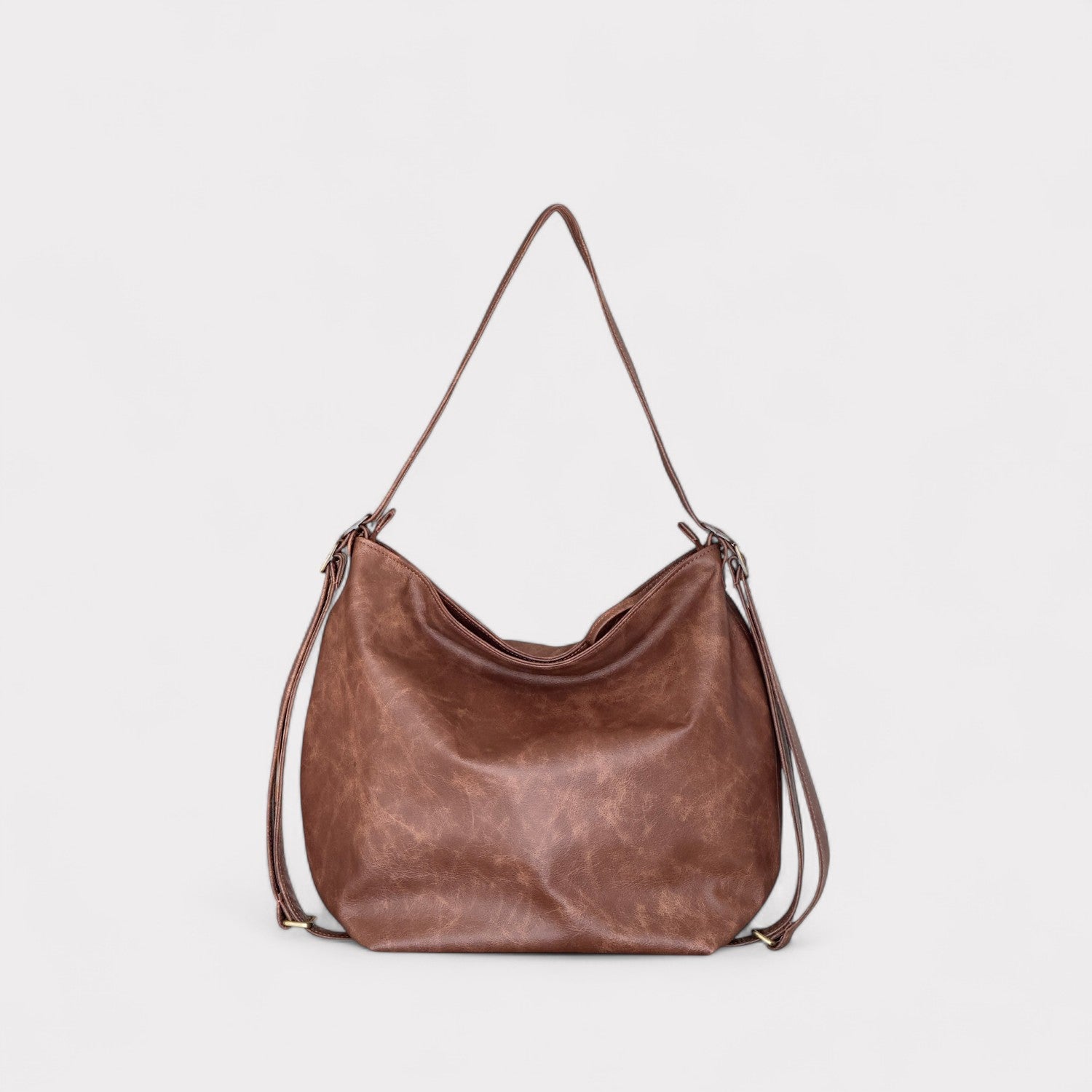 Brown leather handbag on a light gray background