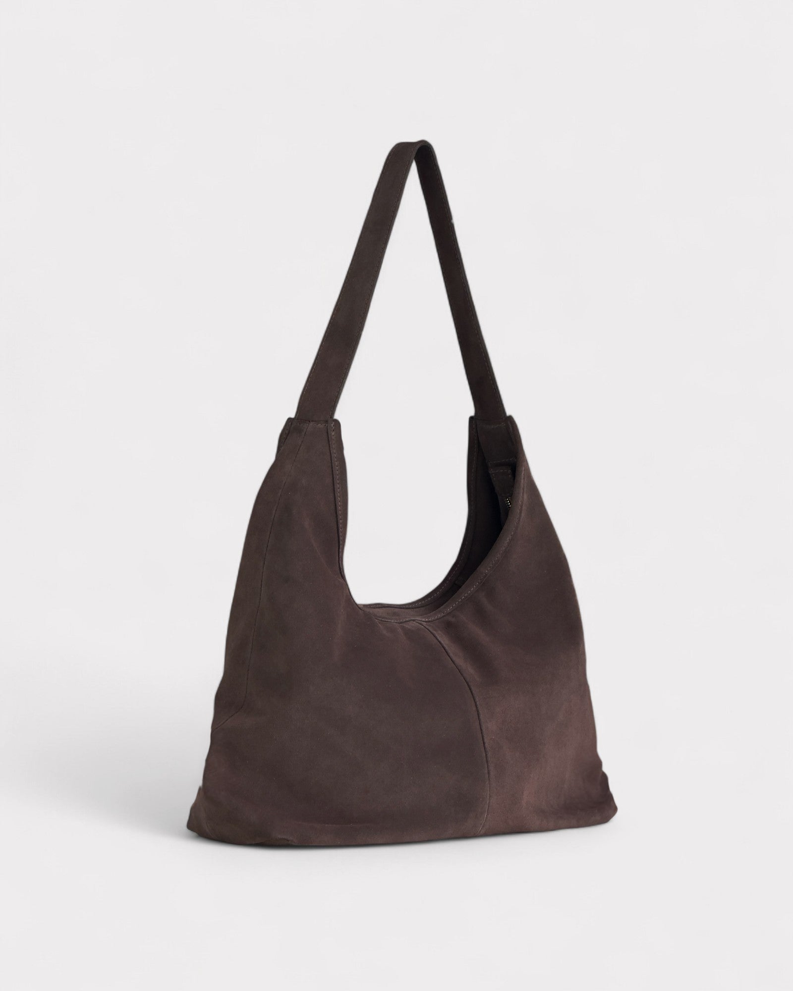 Brown leather shoulder bag on a light gray background