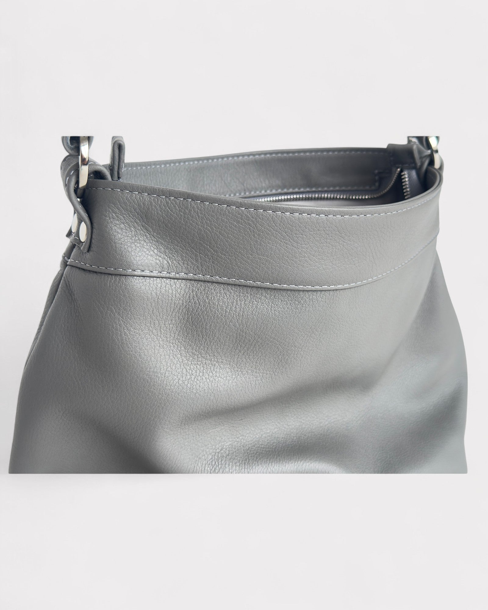 Gray leather handbag on a light gray background