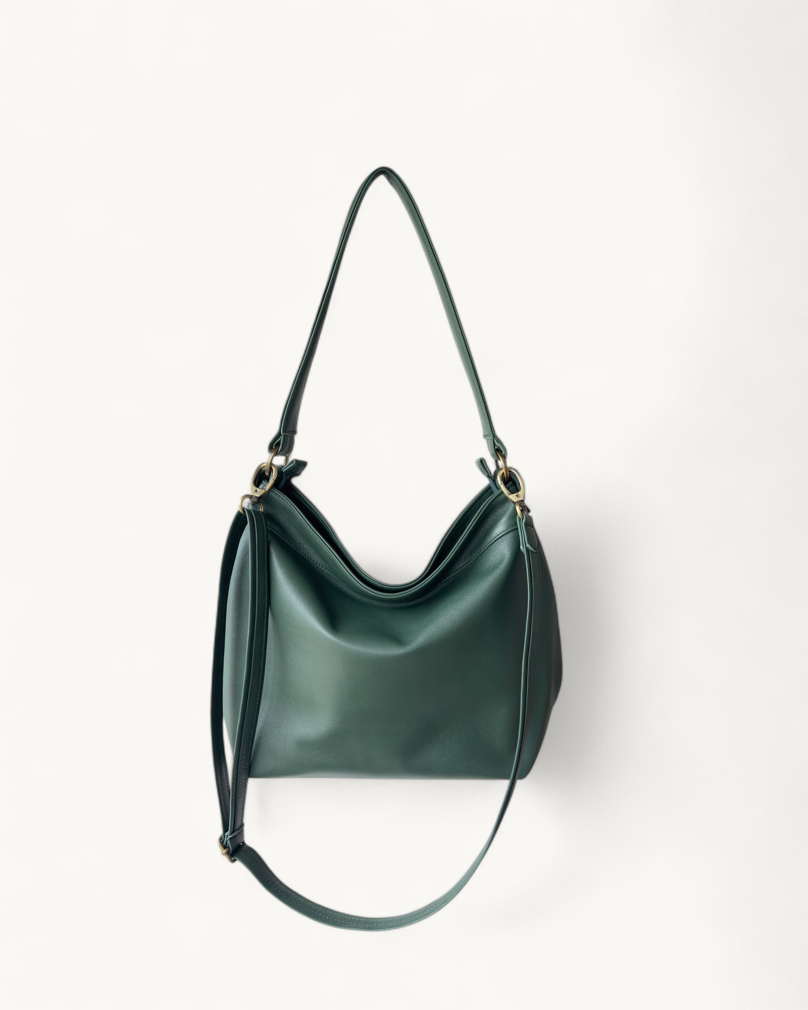 Green handbag with a strap on a white background