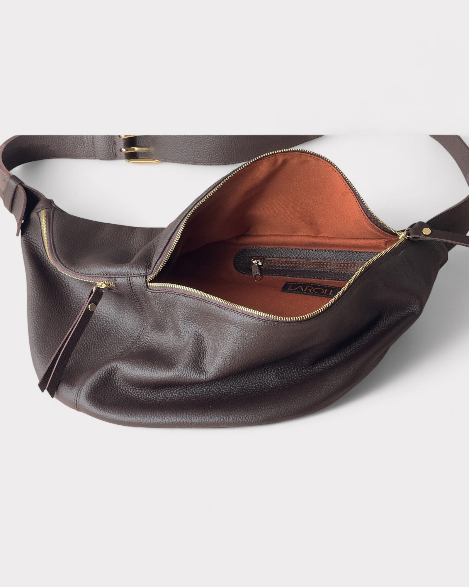 Brown leather handbag with open front pocket on a white background