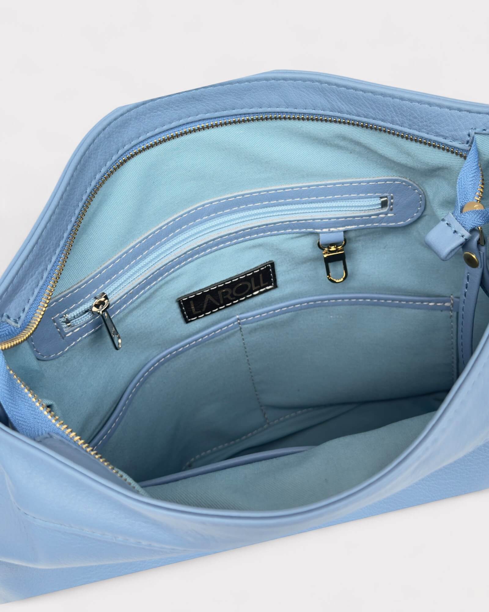 Light blue handbag with visible brand logo on a white background
