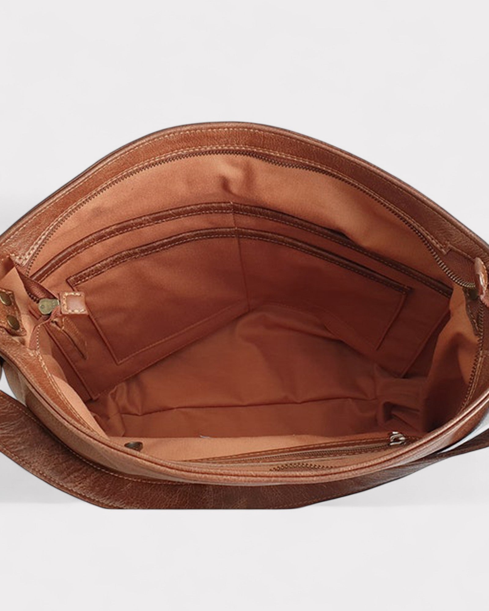 Interior Lining of Brown leather handbag with open top on a white background