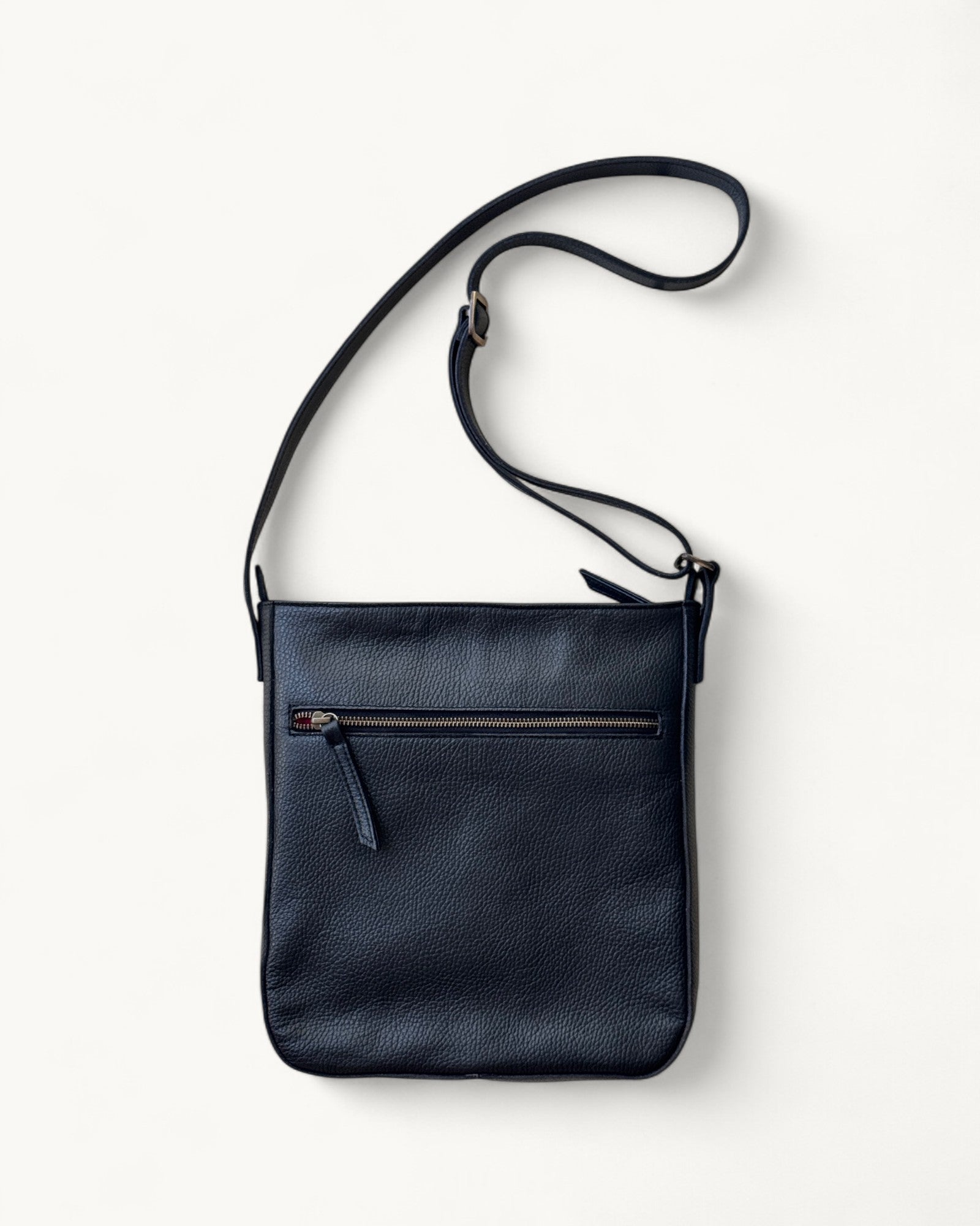 Black leather crossbody bag on a white background