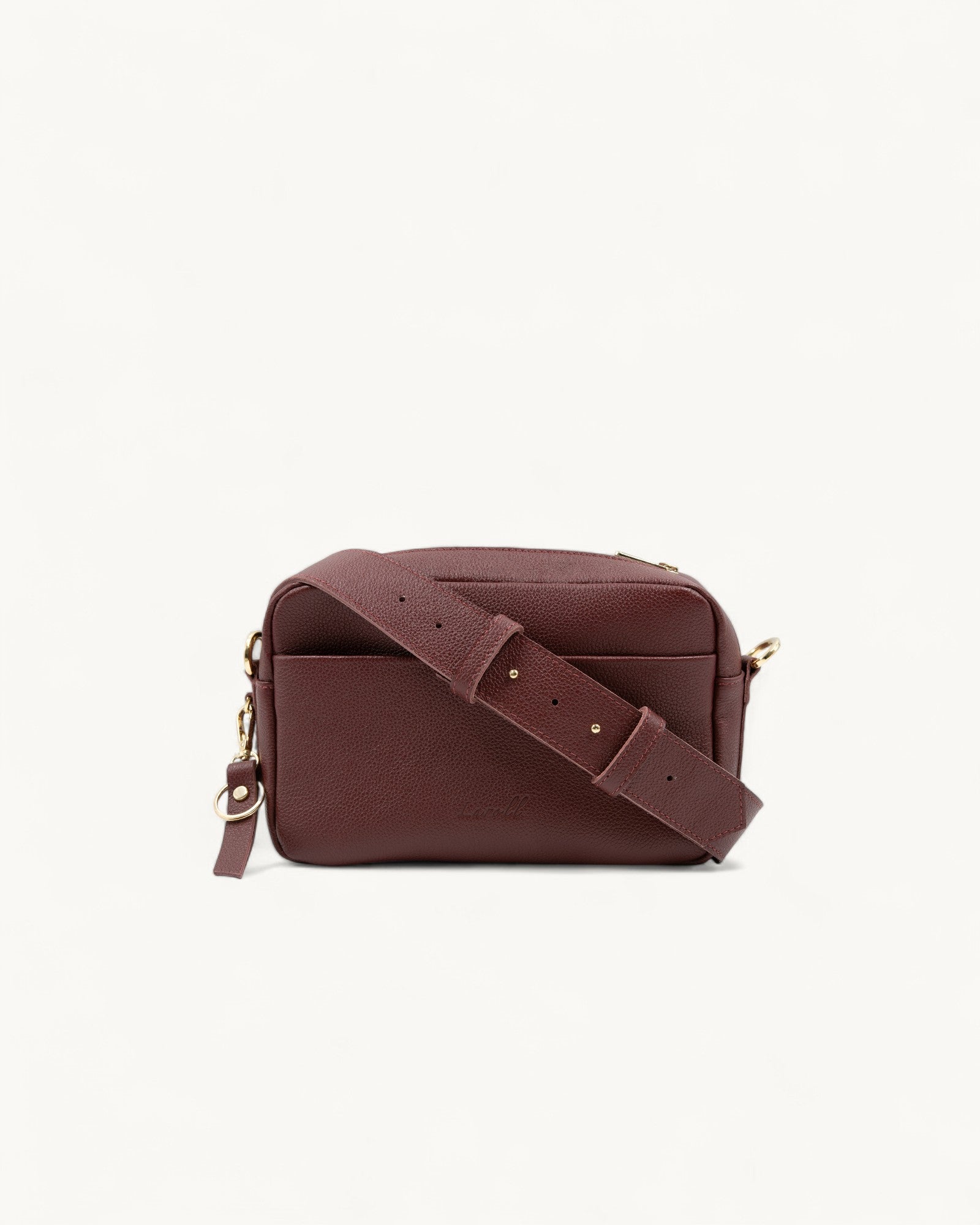 Burgundy leather crossbody bag on a white background