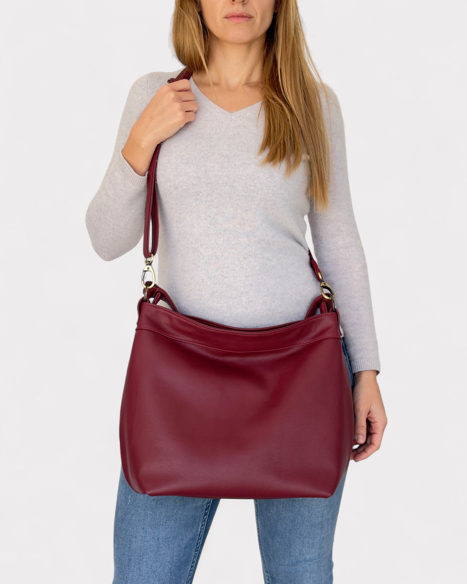 model wearing crossbody medium hobo bag red