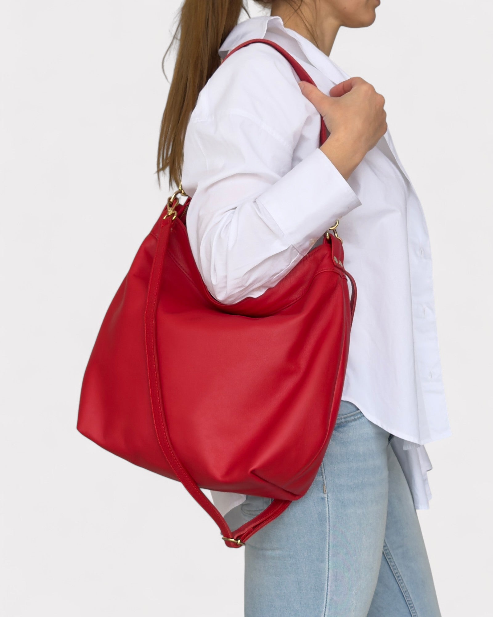 Person wearing a red bag over their shoulder on a white background