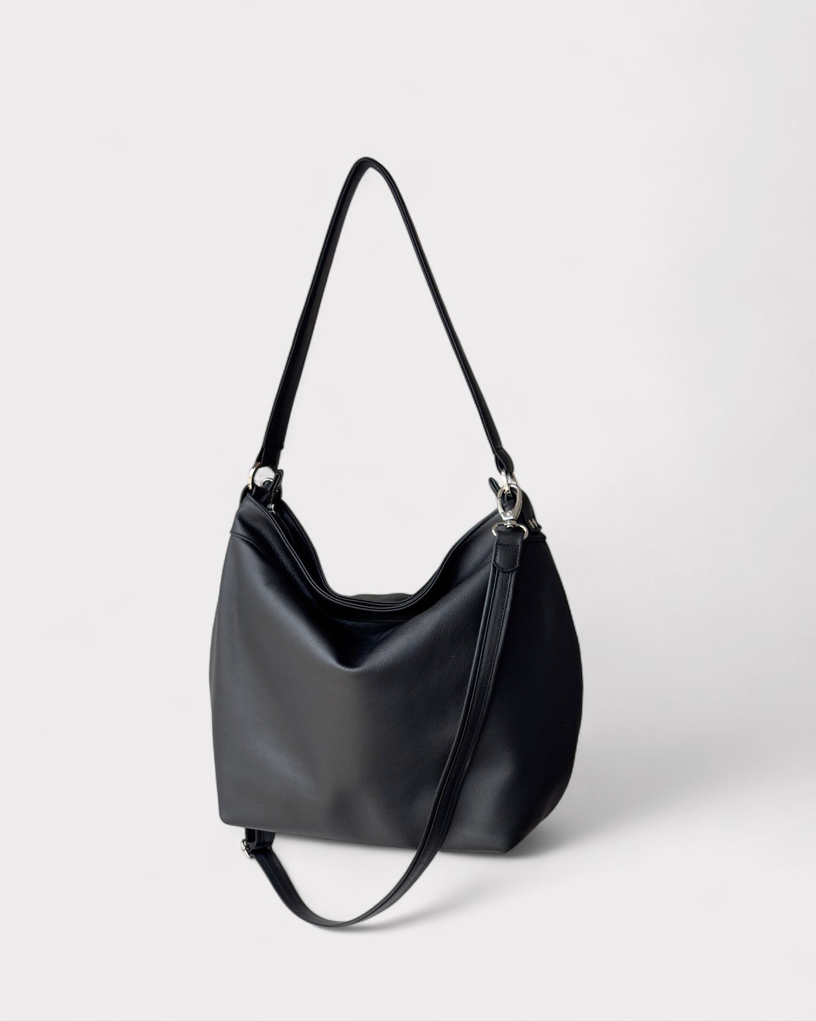 Black handbag on a light gray background