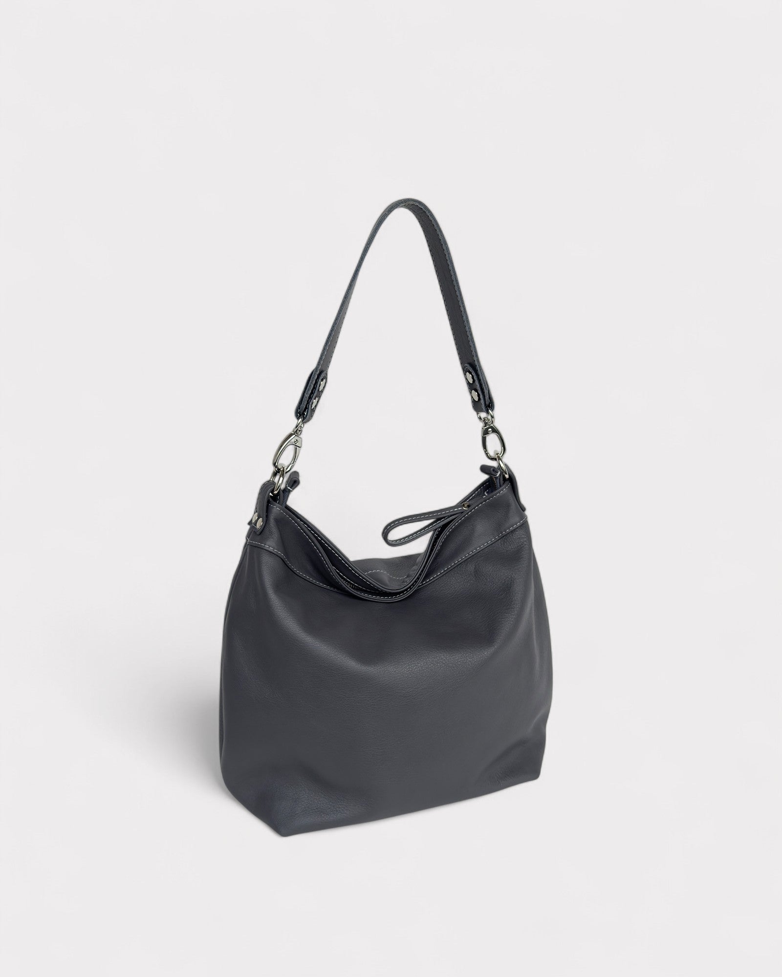Gray handbag with a shoulder strap on a light gray background