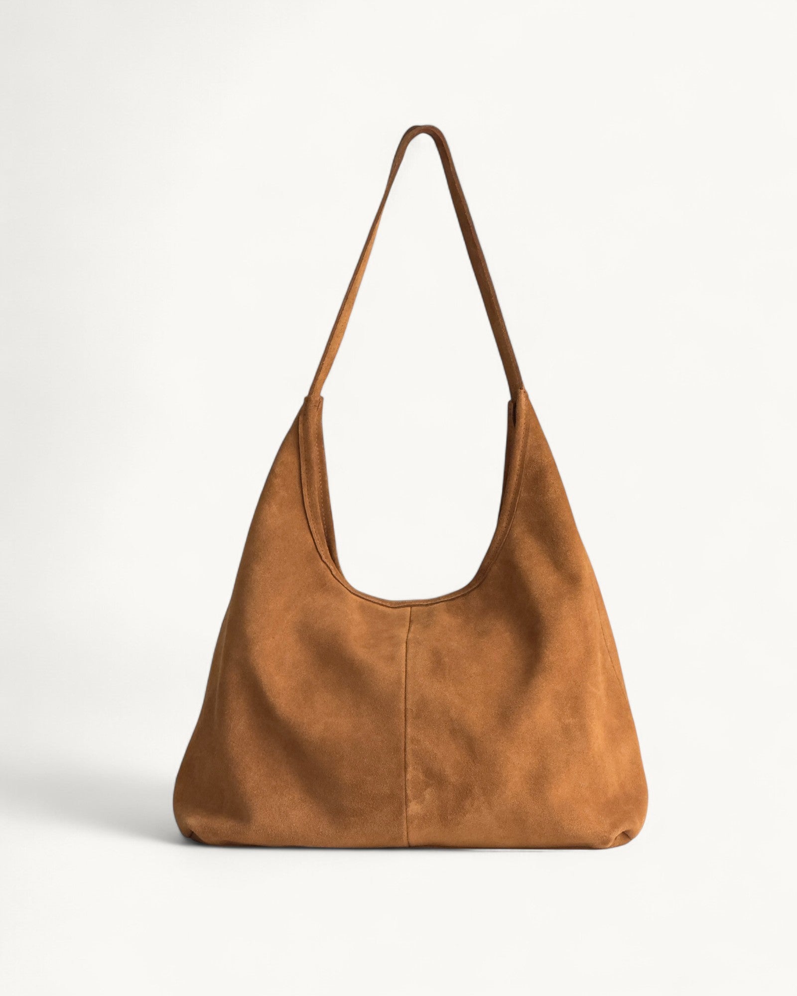 tan leather handbag on a light gray background