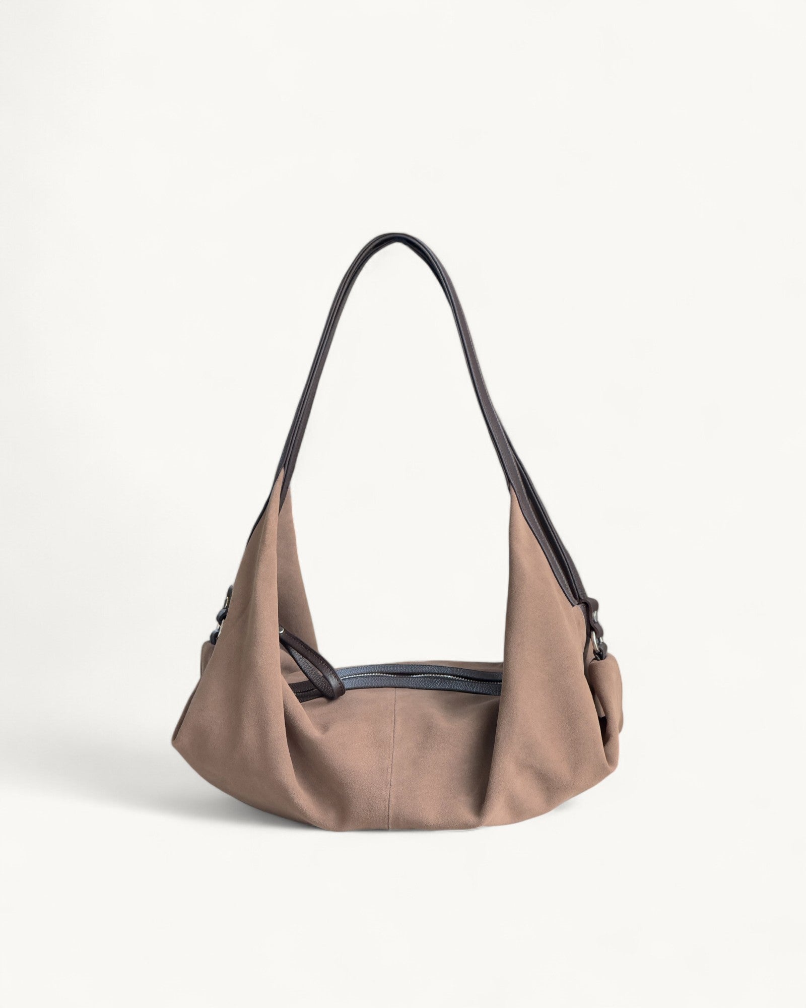 Taupe handbag with dark brown accents on a light beige background