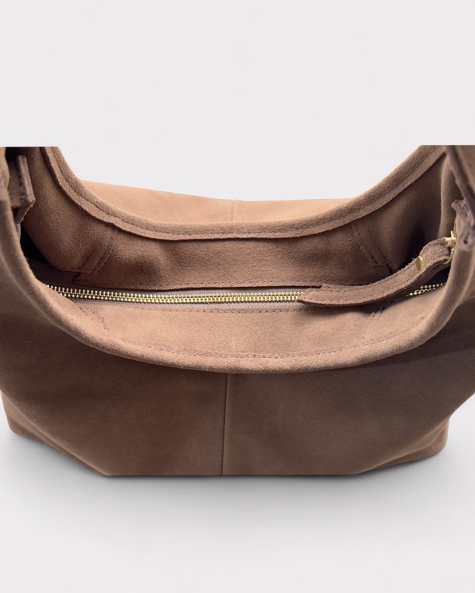 Taupe leather handbag with a gold zipper on a white background