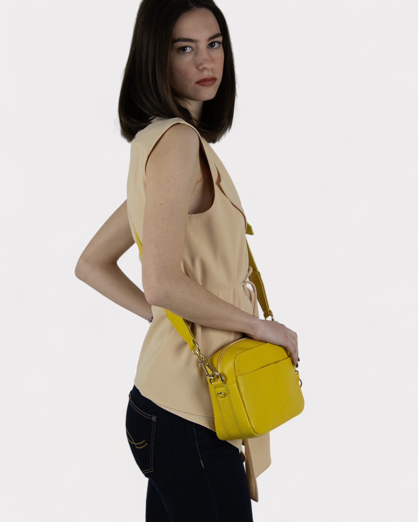 woman wearing yellow camera bag crossbody