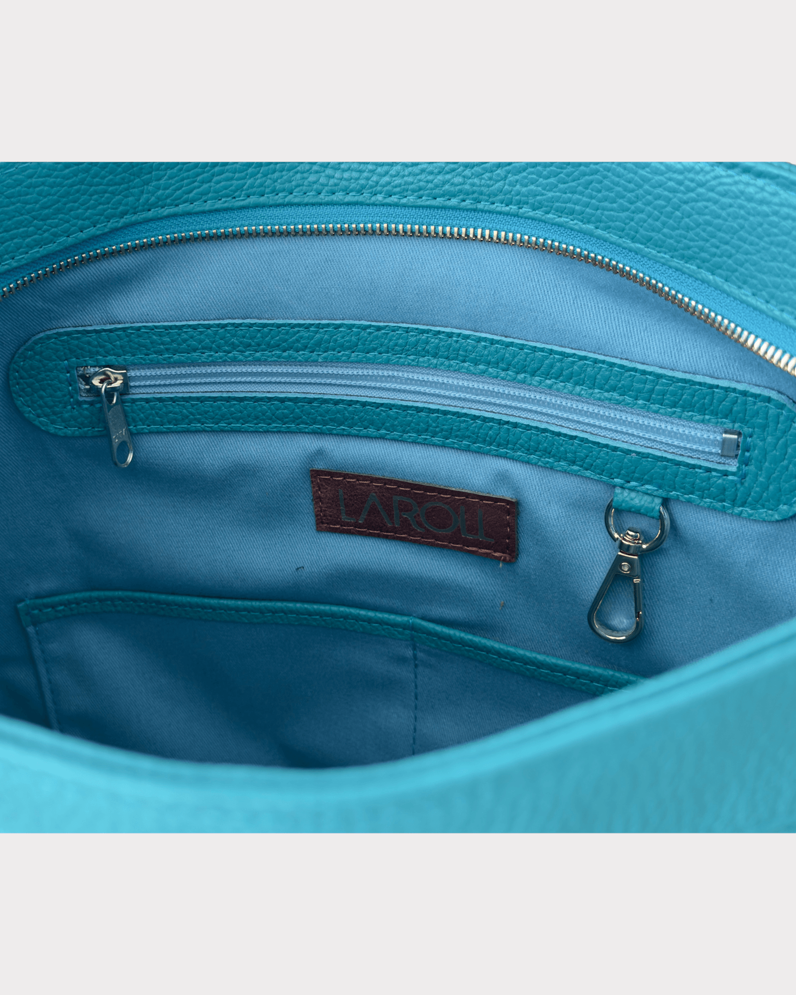 Close-up of a blue bag interior with a visible brand label.