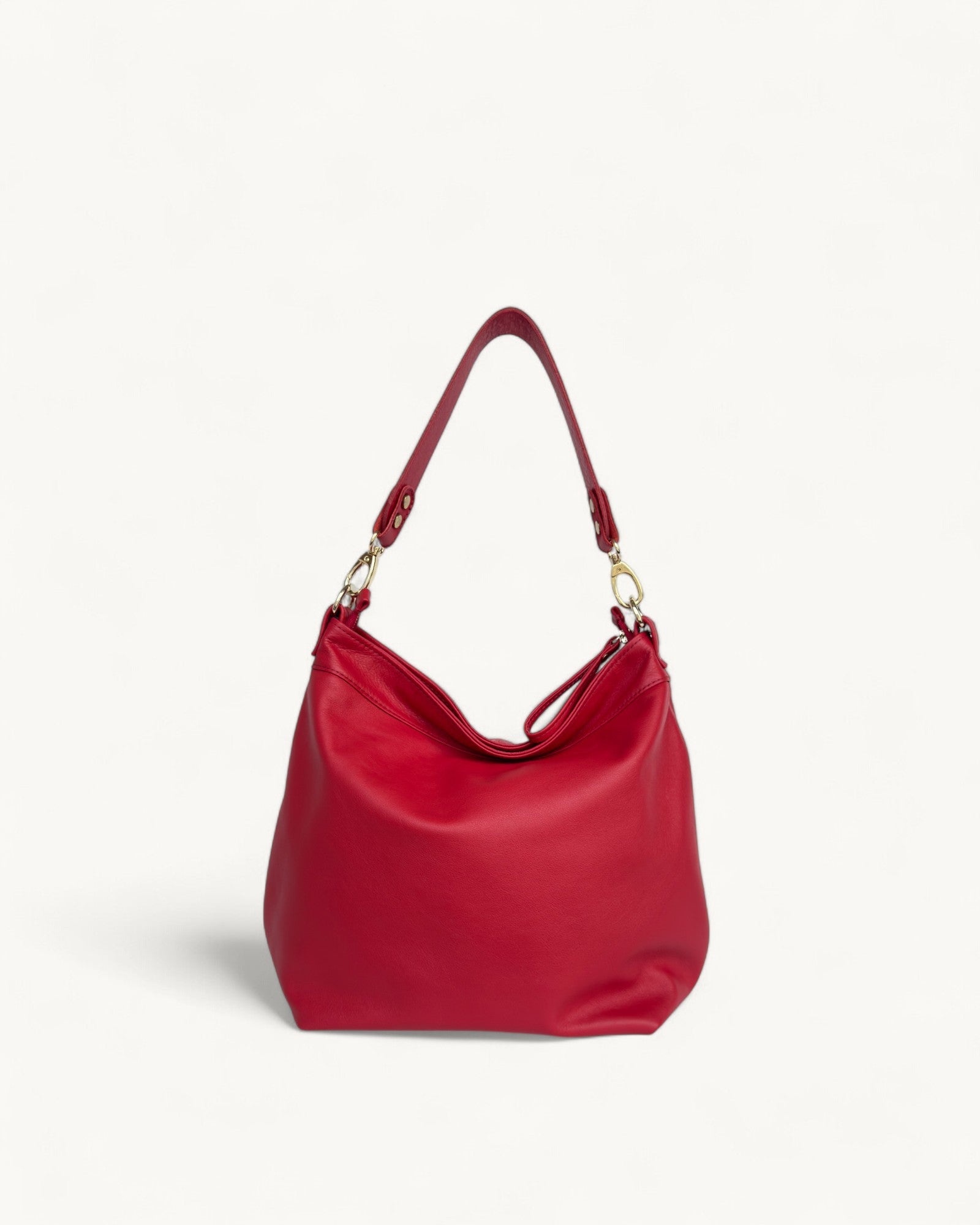 Red handbag with a gold clasp on a light gray background