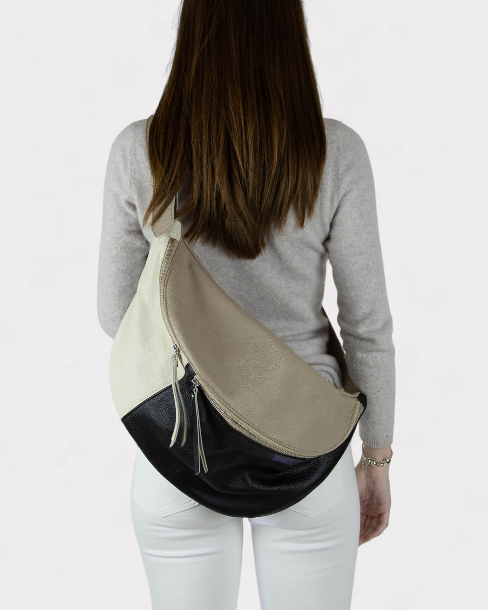 Woman wearing a two-tone black and white sling bag