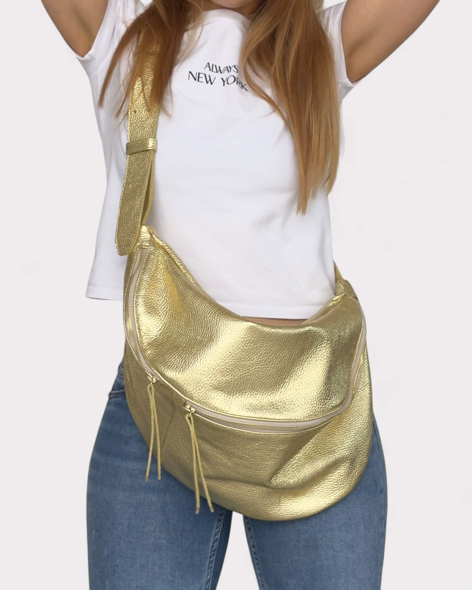 Person wearing a gold metallic bag with a plain background