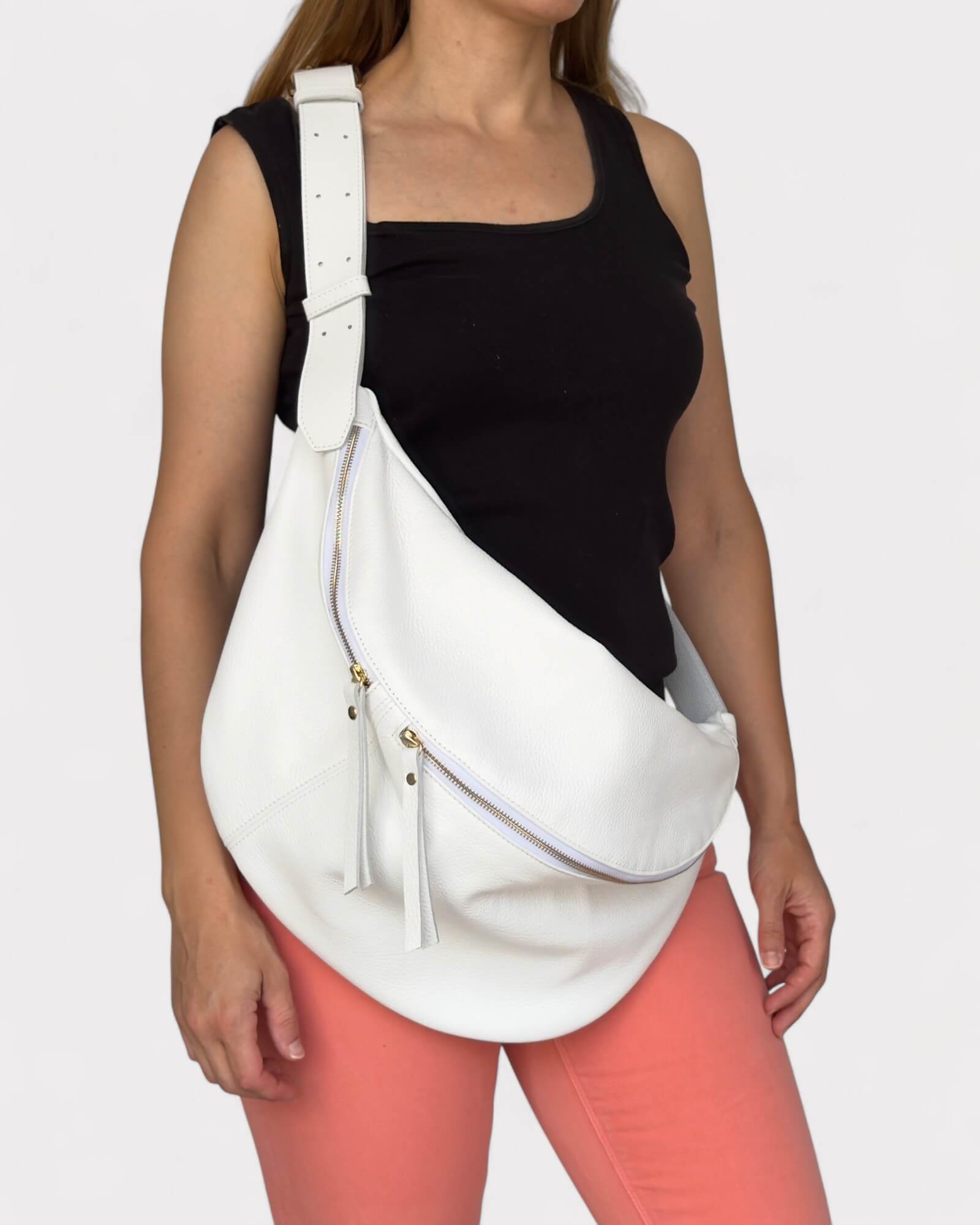 Person wearing a white banana bag on a plain background