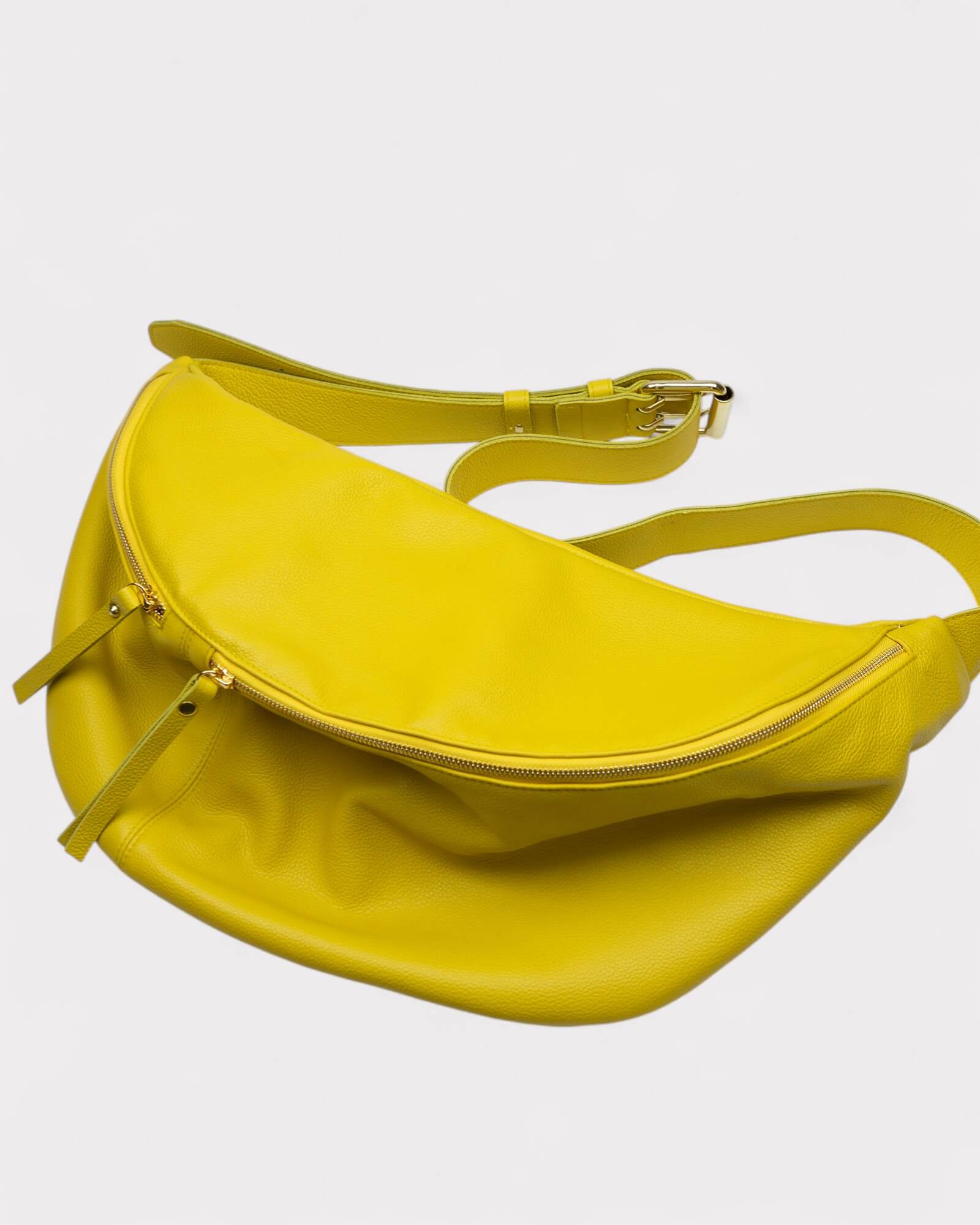 Yellow banana-shaped bag on a light gray background