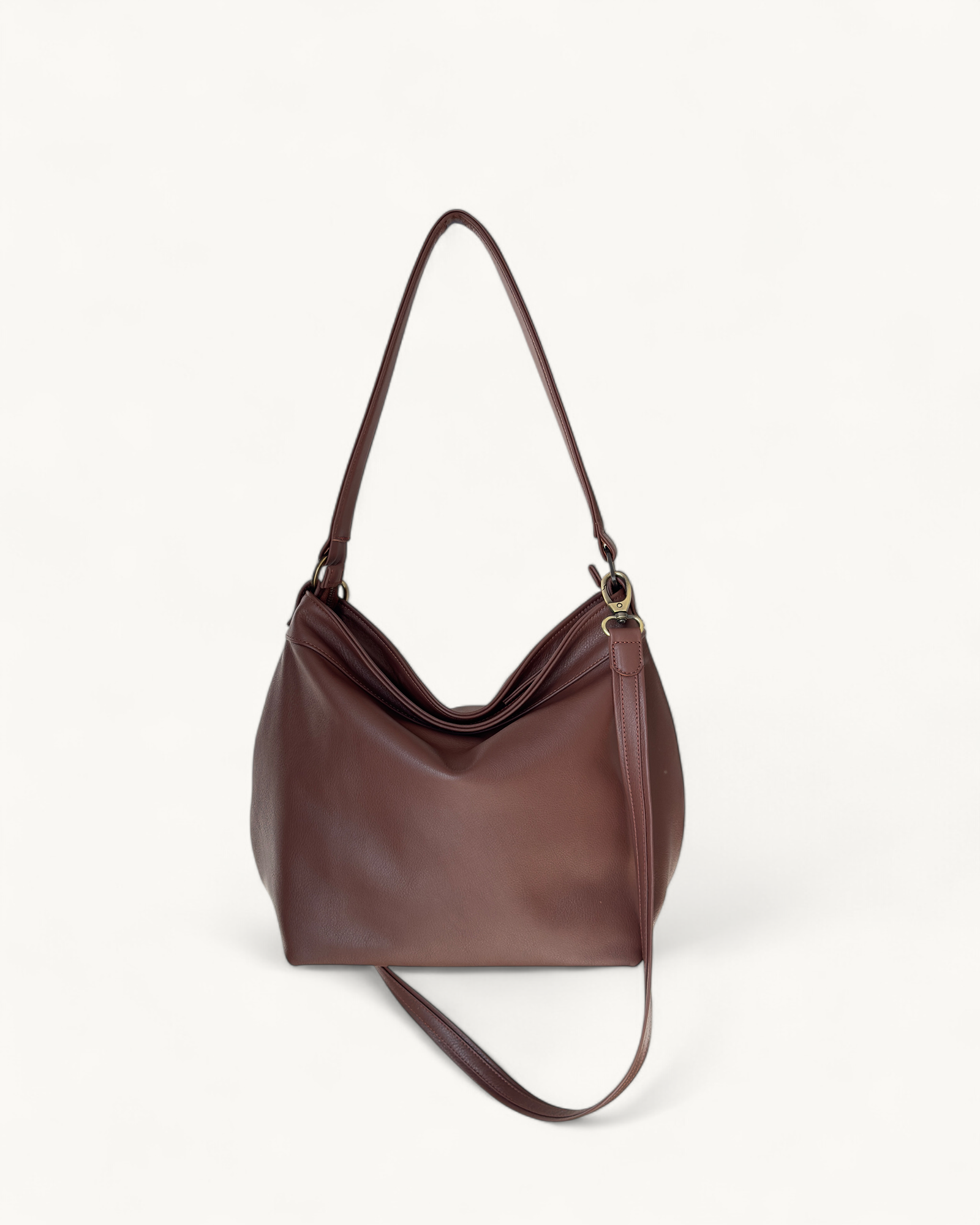Brown leather handbag on a light beige background