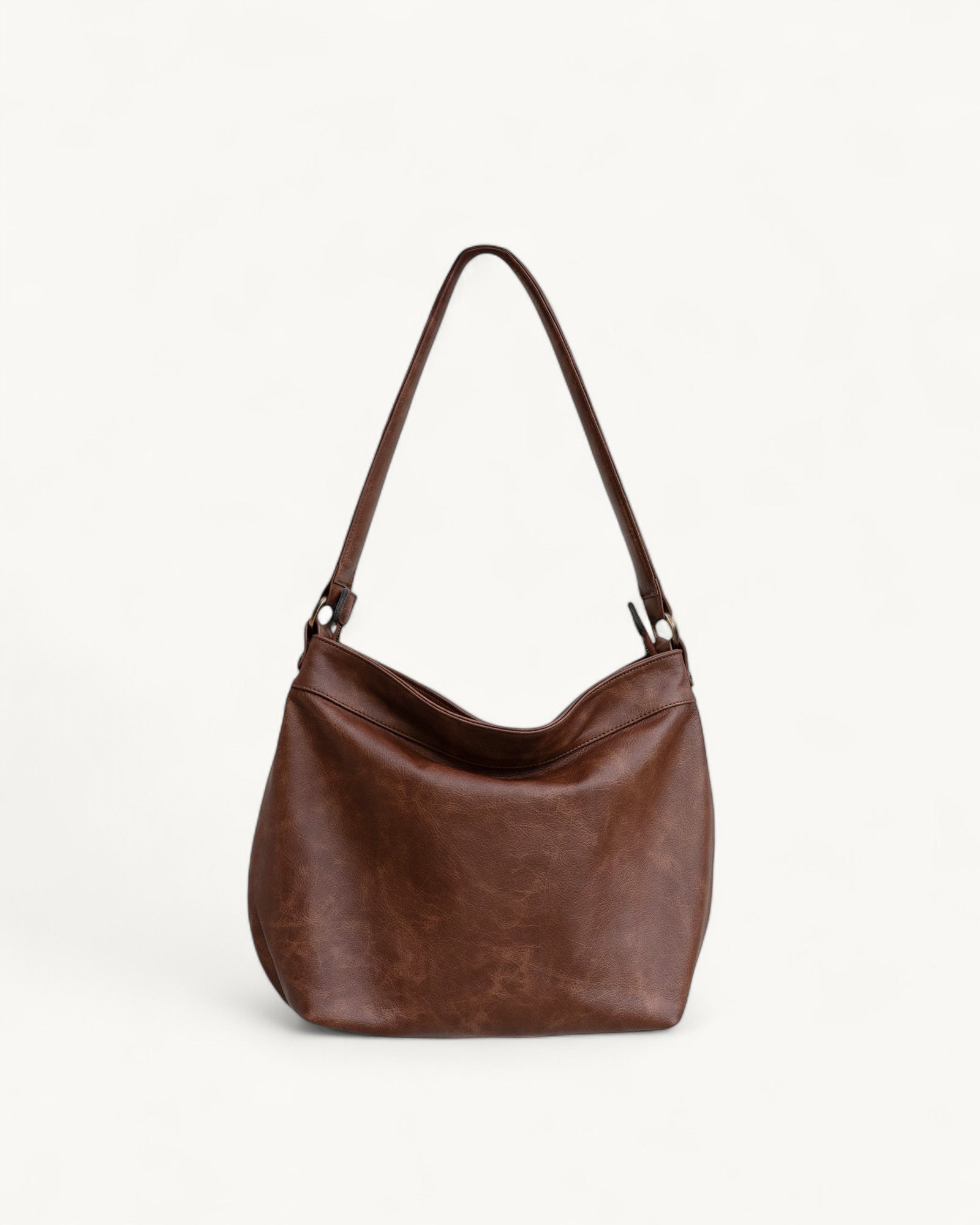 Brown leather handbag on a light beige background