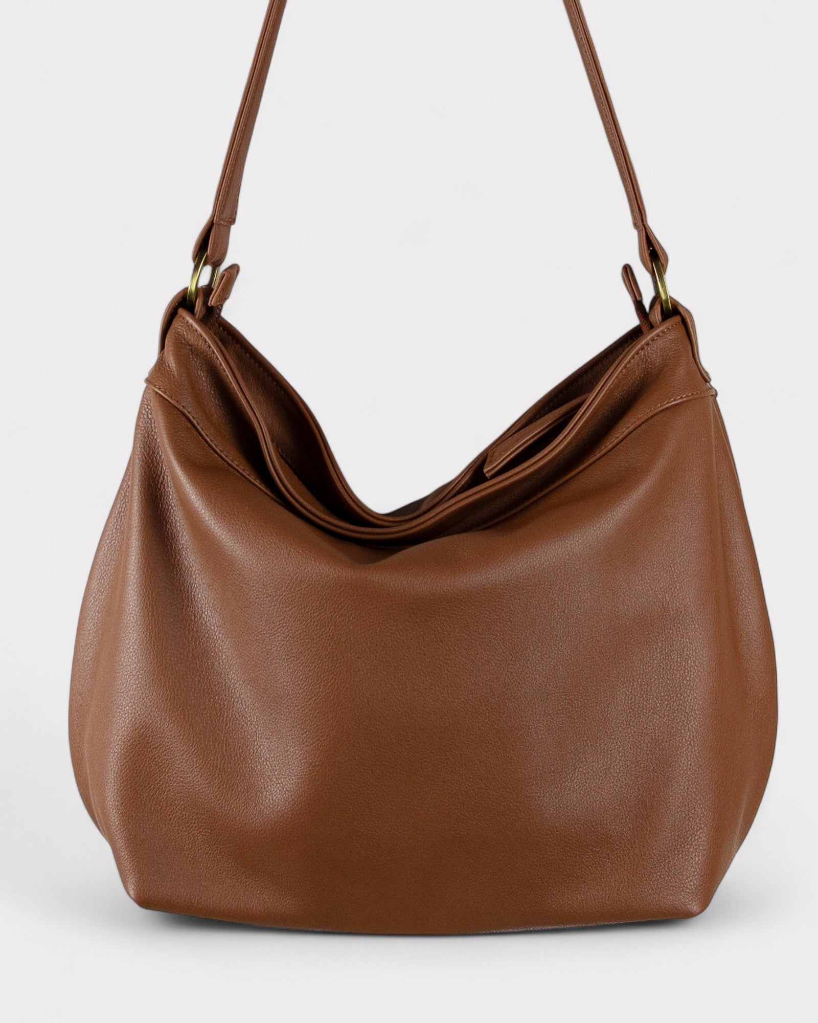 Cognac brown leather handbag on a white background