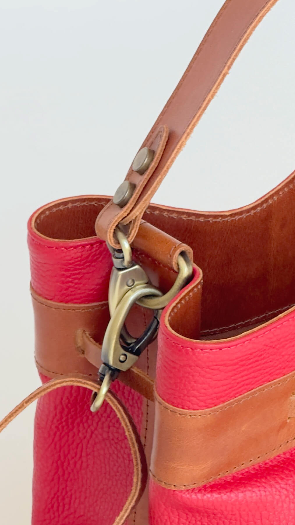detail of the strap of red bucket bag