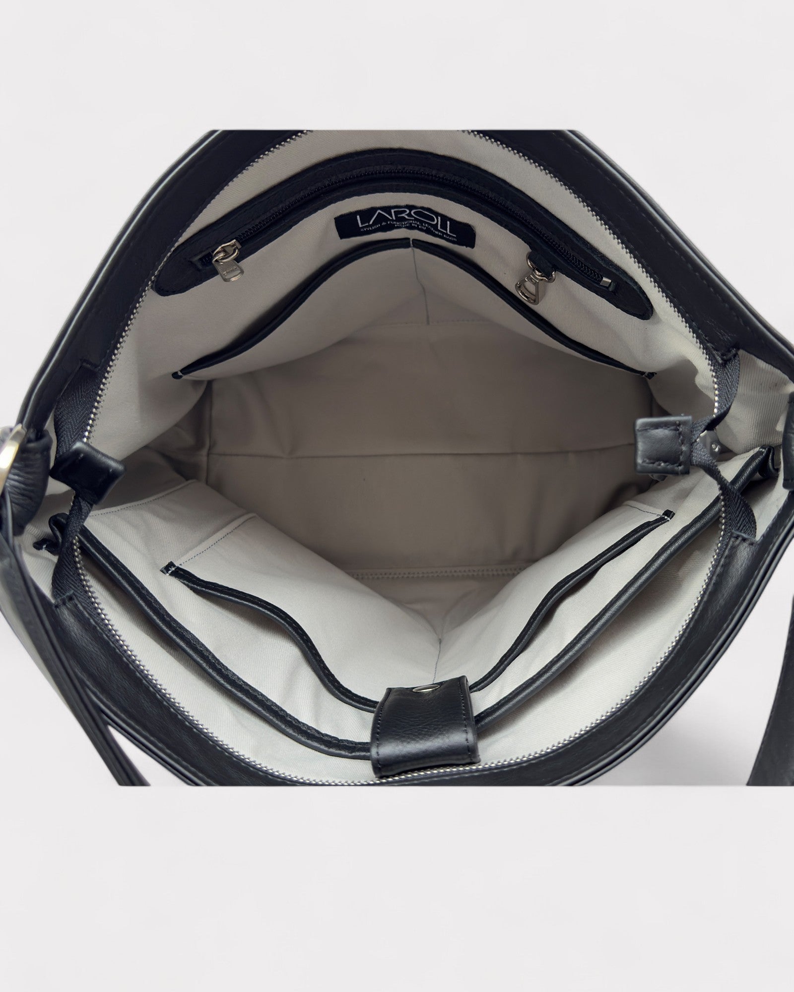 Open black handbag with visible interior and brand logo on a light gray background