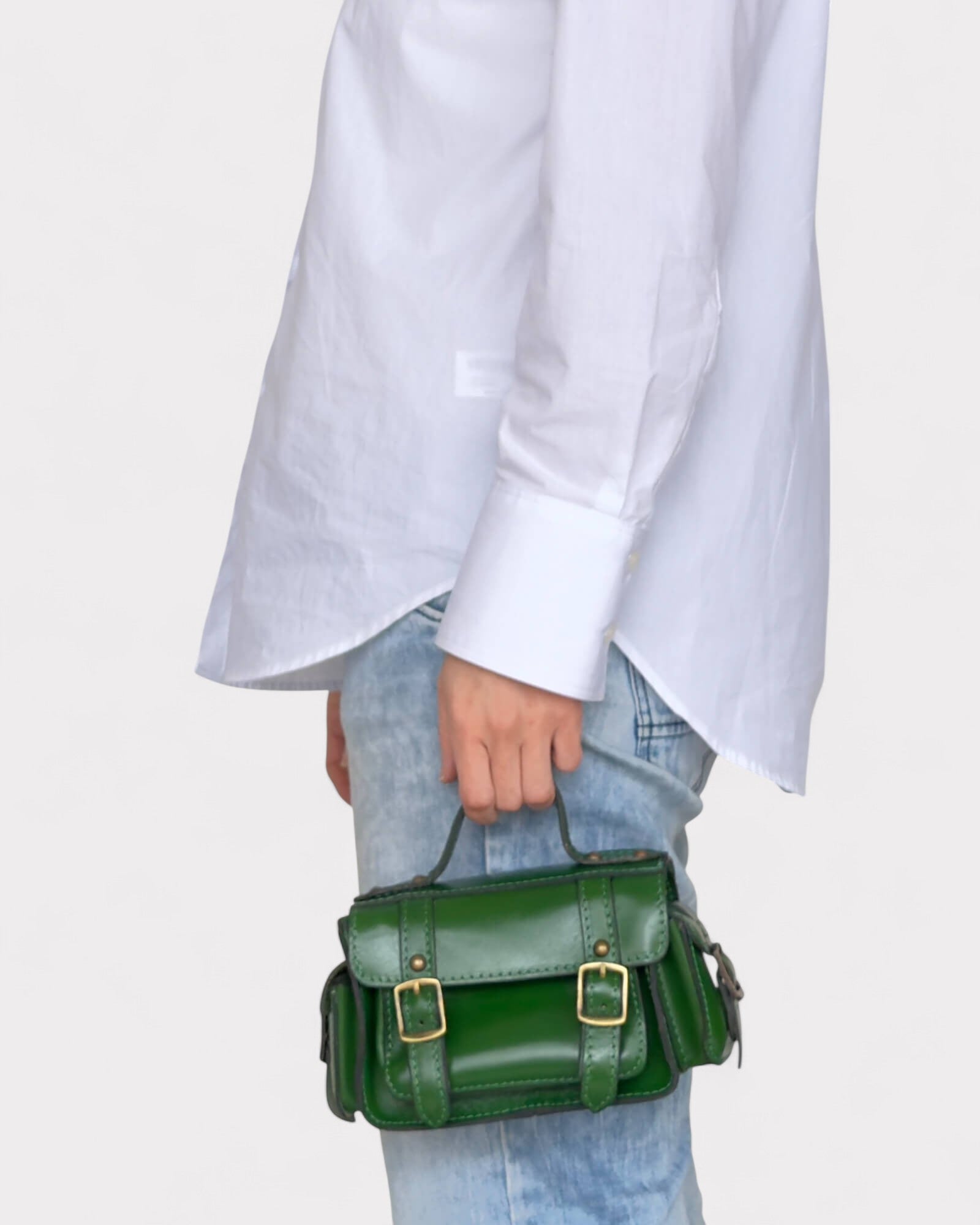 model carrying green satchel crossbody bag on hands