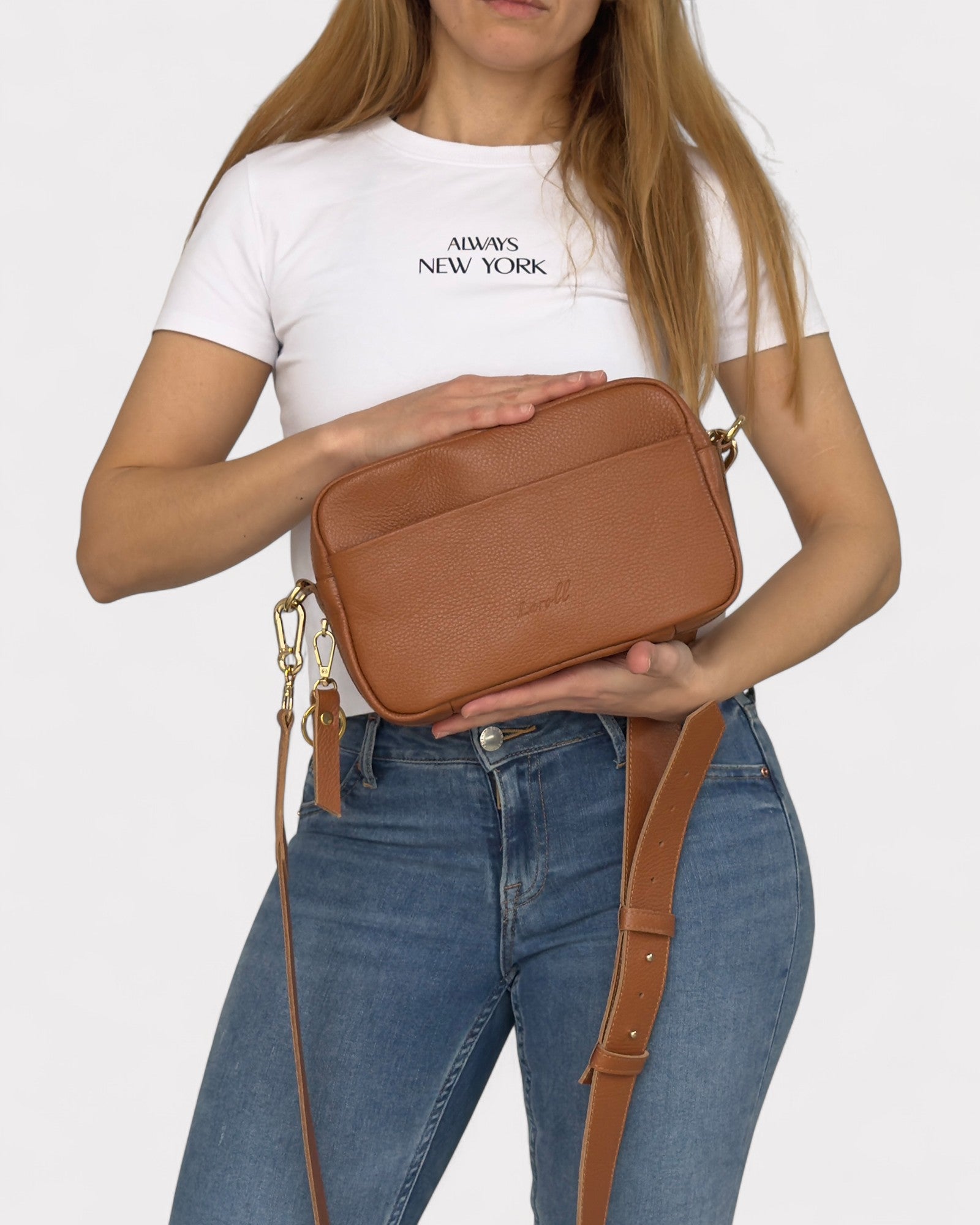 model holding tan camera bag
