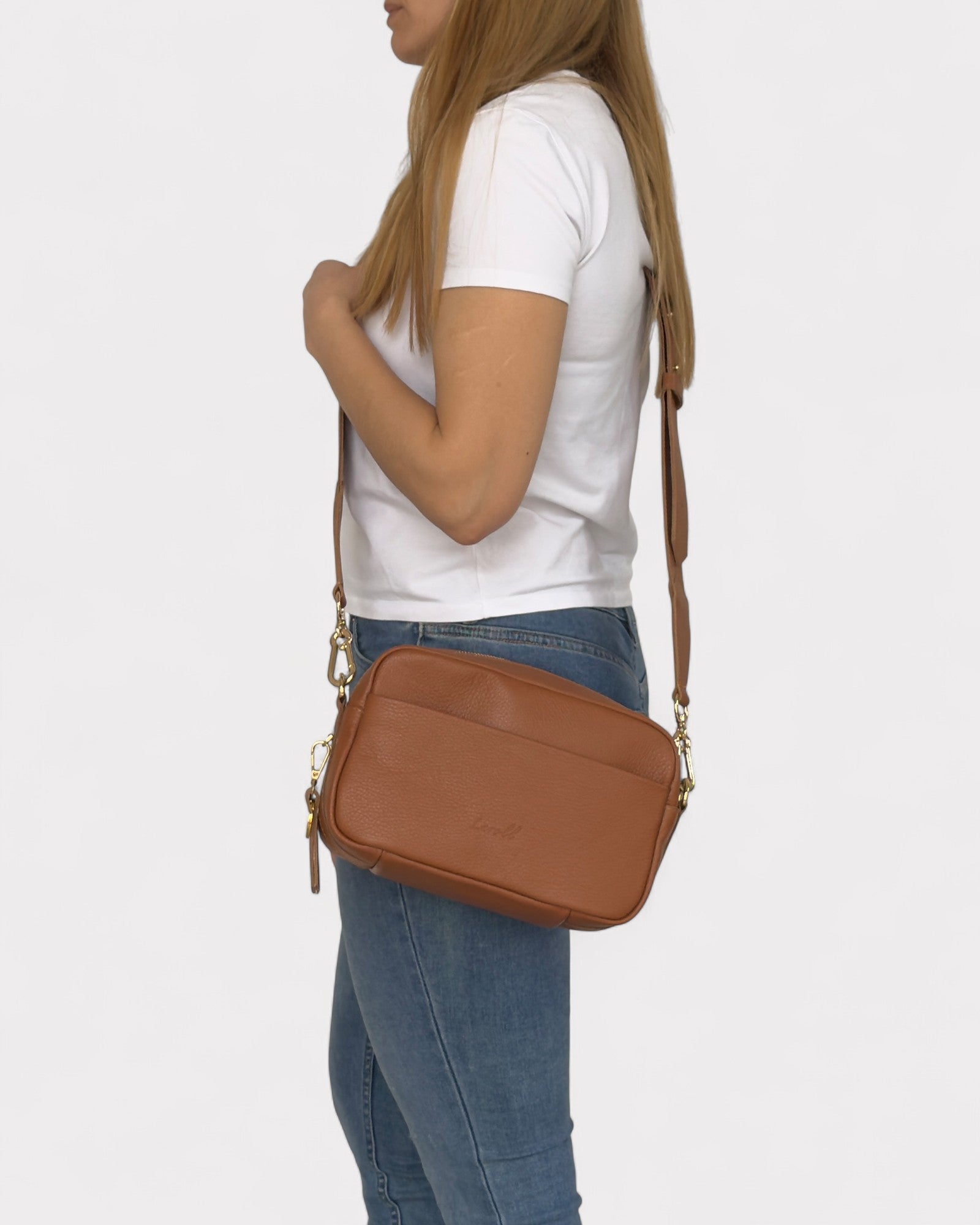 model wearing tan camera bag crossbody