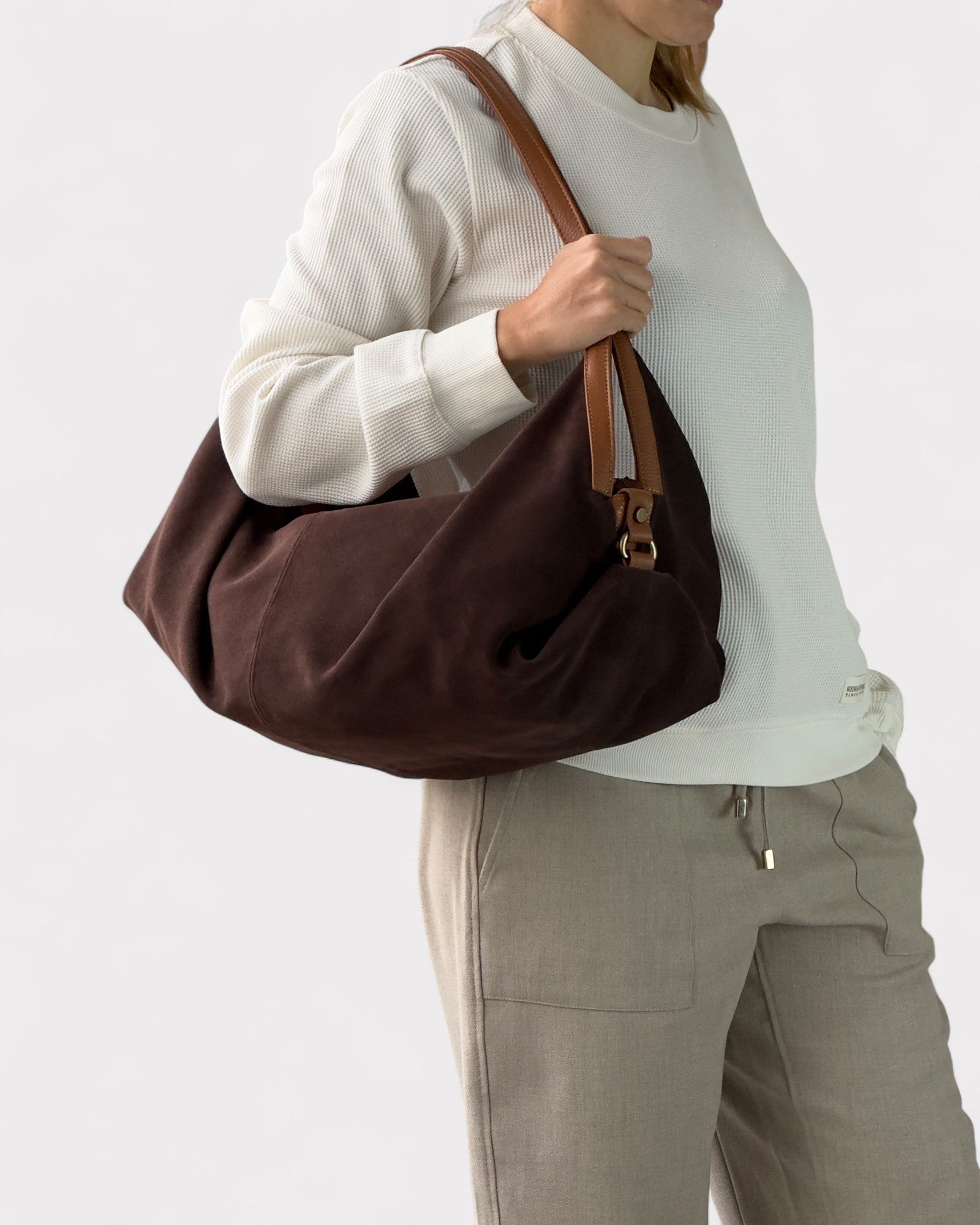 girl wearing dark brown suede handbag deluna