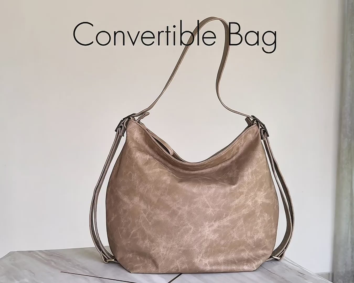 video of beige convertible hobo bag