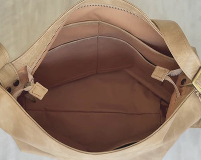 video of beige convertible hobo bag what it fits inside