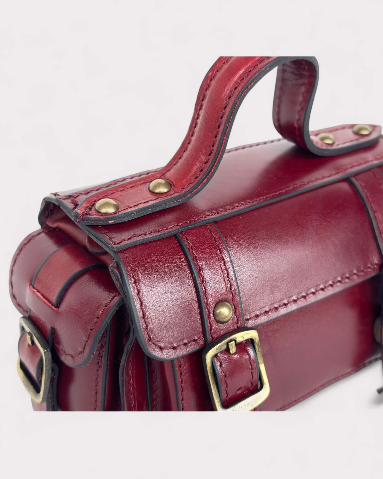 red crossbody bag brass hardware details