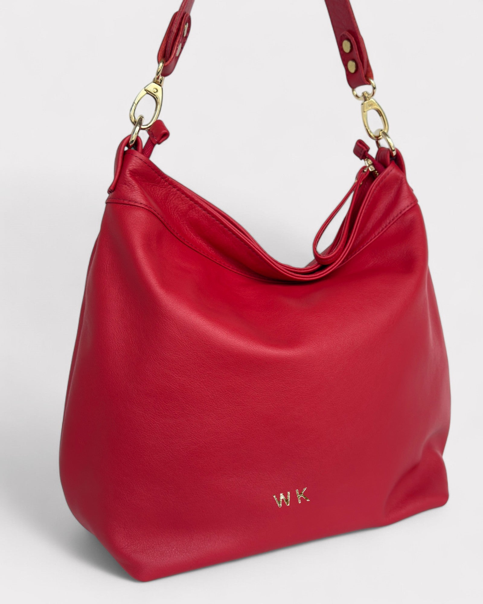 Red handbag with gold hardware on a white background