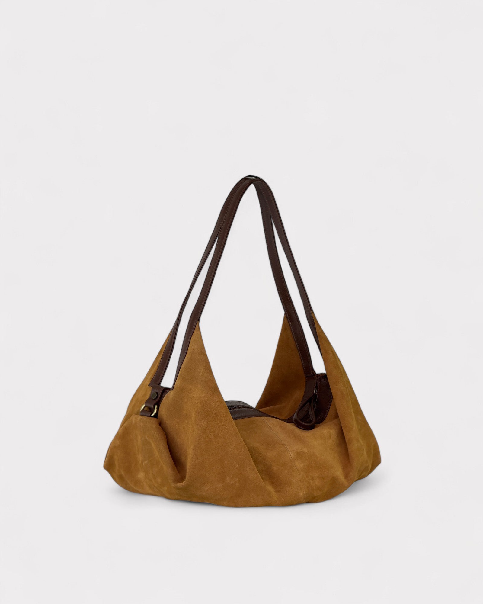Tan handbag with a strap on a light gray background