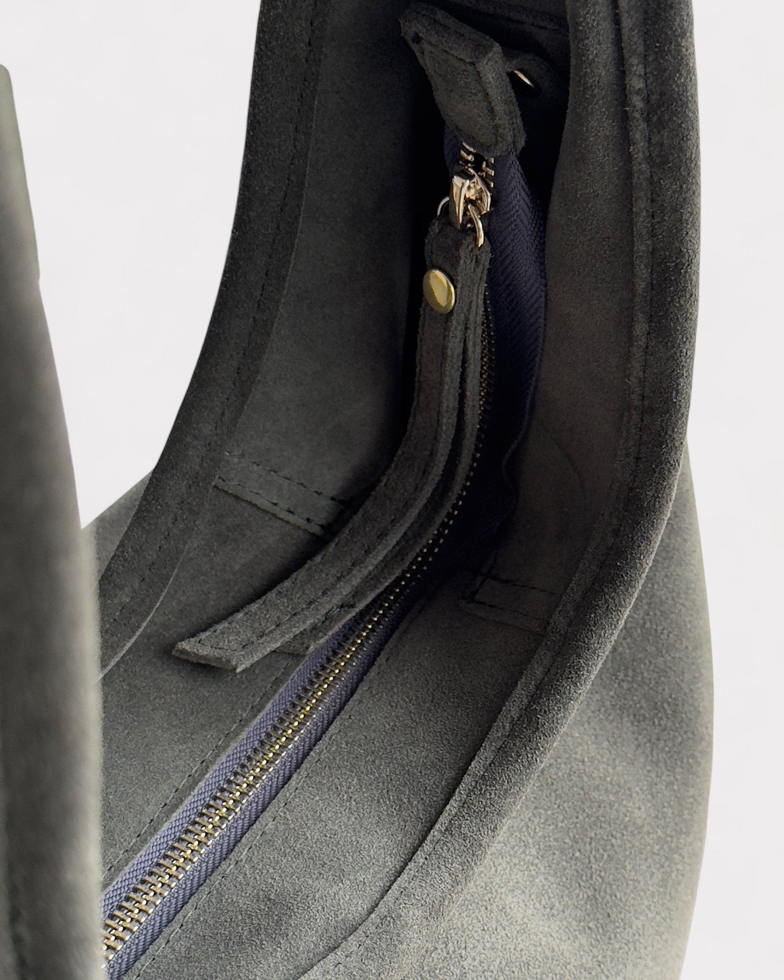 Green bag with a zipper on a light gray background